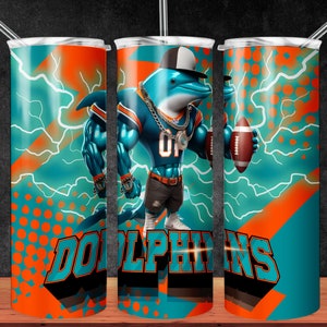 May include: A turquoise and orange tumbler with a cartoon dolphin wearing a jersey and holding a football. The tumbler has the word "DOLPHINS" printed on it.