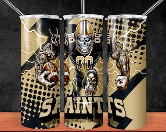 May include: A black and gold tumbler with a graphic of a football player wearing a helmet with a skull design. The tumbler has the word "Saints" printed on it.