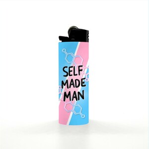 May include: A cylindrical lighter with a black top and a blue, pink, and white design. The lighter has the words "SELF MADE MAN" in black, with a molecular structure design in white and light blue.