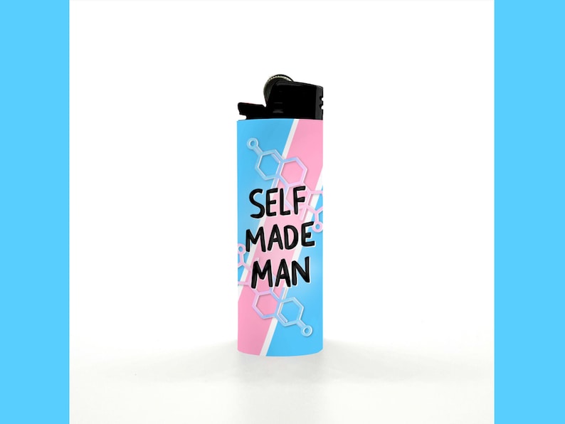 May include: A cylindrical lighter with a black top and a blue, pink, and white design. The lighter has the words "SELF MADE MAN" in black, with a molecular structure design in white and light blue.