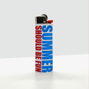May include: A white lighter with the words "SUMMER SHOULD BE FUN" printed vertically in blue and red. The lighter has a red ignition button and a metal top.
