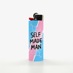 May include: A blue, pink, and white lighter with the text "SELF MADE MAN". The lighter has a black top with a red button. The design includes geometric shapes.