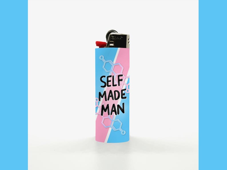 May include: A blue, pink, and white lighter with the text "SELF MADE MAN". The lighter has a black top with a red button. The design includes geometric shapes.