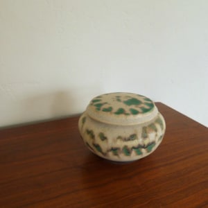 May include: A set of three ceramic mugs with a speckled, matte finish. The mugs are in shades of cream, light gray, and dark gray. Each mug has a simple, minimalist design, perfect for coffee or tea.