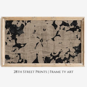 May include: A framed abstract print with a black and beige floral pattern. The frame is a light wood colour. The text "28TH STREET PRINTS | FRAME TV ART" is below the frame.