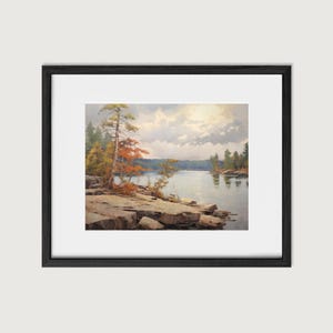 May include: A framed painting of a lake scene with a rocky shoreline and trees. The sky is cloudy and the water is calm. The colors are muted and the overall tone is peaceful.