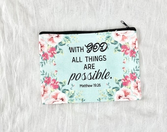May include: A light blue zippered pouch with a floral pattern and the text "With God all things are possible. Matthew 19:26"