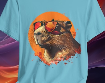May include: A light blue t-shirt with a graphic of a brown and white rodent wearing sunglasses. The rodent is in front of a large orange circle with a splatter of orange and red paint.
