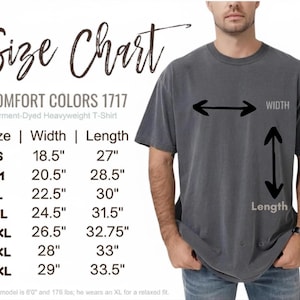 May include: A charcoal grey short-sleeve t-shirt with a size chart displaying Comfort Colors 1717 garment-dyed heavyweight t-shirt measurements in inches for sizes S through 4XL, including width and length dimensions with directional arrows.
