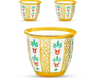 May include: Set of four white ceramic coffee cups with gold trim and intricate floral designs in green, red, and gold. The cups are traditional Arabic style.