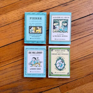 May include: Four small hardcover books by Maurice Sendak titled Pierre, Alligators All Around, One Was Johnny, and Chicken Soup with Rice. Each book features a distinct illustrated cover with black text on light blue, white, or pale yellow backgrounds.