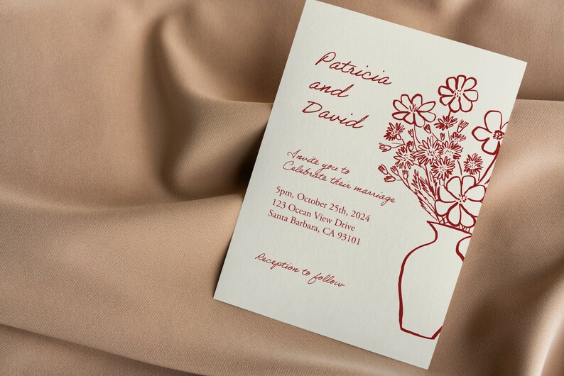 May include: Wedding invitation with a red floral illustration and the text "Patricia and David Invite you to Celebrate their marriage 5pm, October 25th, 2024 123 Ocean View Drive Santa Barbara, CA 93101 Reception to follow"