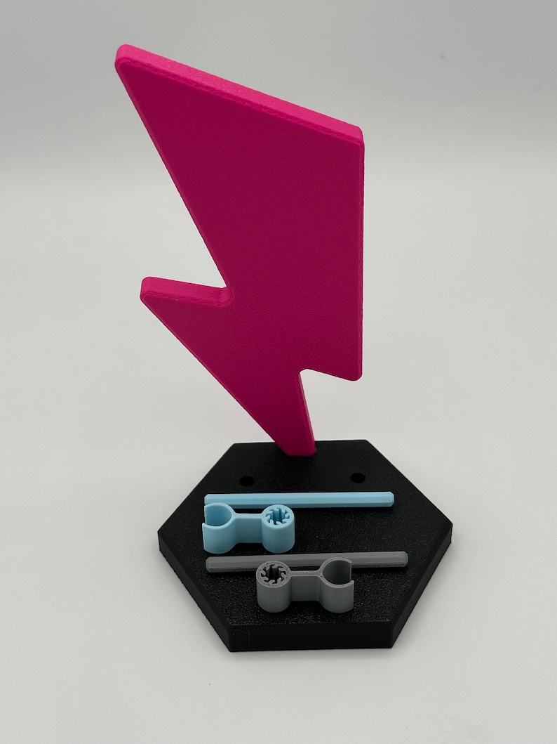 3D printed pink lightning bolt shaped doll stand with a black hexagonal base