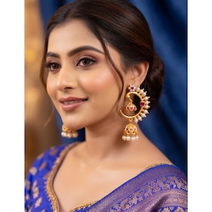 May include: A white ceramic mug with a black handle and the text "But First, Coffee" in a black, handwritten-style font. The mug is on a white surface.