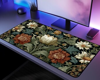 May include: A rectangular desk mat featuring a floral design with large, detailed flowers in shades of cream, rust, and yellow against a dark background. The mat is designed to fit under a computer and keyboard.