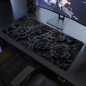 May include: Black and white mousepad with a design of black roses. The roses are arranged in a repeating pattern and have a 3D effect.