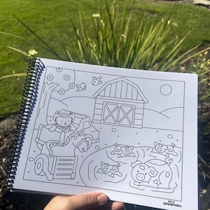 May include: A spiral-bound coloring book featuring a farm scene with a barn, tractor, and animals. The black and white illustrations include a bear driving a tractor, cows, and pigs. The text "Lili's Adventures" is visible.