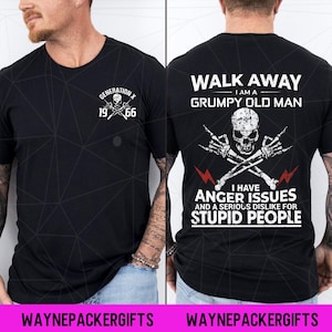 May include: Black t-shirt with white graphic text and skull designs. The front of the shirt reads "GENERATION X 1966". The back of the shirt says "WALK AWAY I AM A GRUMPY OLD MAN I HAVE ANGER ISSUES AND A SERIOUS DISLIKE FOR STUPID PEOPLE".