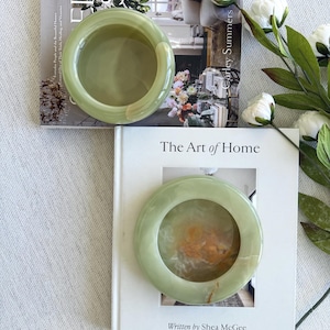 May include: A rustic wooden sign with the text "Welcome to our home" in white lettering. The sign features a distressed finish and a simple, inviting design, perfect for entryway decor.