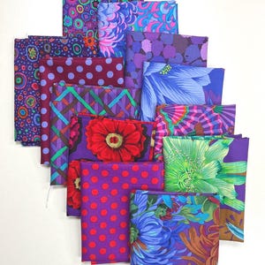 以下が含まれることがあります： 紫、青、赤の色合いの花柄、幾何学模様、水玉模様のファブリック正方形が12枚重ねられています