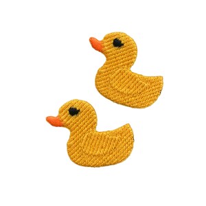 May include: Two yellow rubber ducky patches with black eyes and orange beaks.