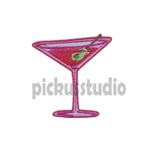 May include: Pink and red embroidered iron-on patch of a martini glass with an olive.