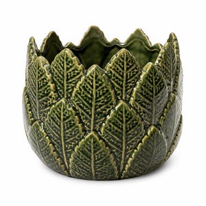 May include: A dark green ceramic planter featuring a textured, overlapping leaf pattern that covers the entire exterior. The rim has a jagged, pointed edge design that mimics the shape of individual leaves, creating a rounded, bowl-like form.