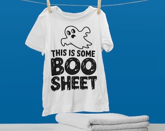 May include: White t-shirt with a black ghost graphic and the text "This is some BOO SHEET".