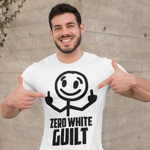 May include: White t-shirt featuring a black stick figure graphic giving the middle finger, with the text "ZERO WHITE GUILT" in black. The person wearing the shirt is pointing at the graphic.