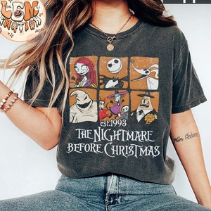 May include: A black t-shirt with a vintage-style graphic of characters from the movie "The Nightmare Before Christmas". The graphic features Jack Skellington, Sally, Oogie Boogie, and Zero. The text "est. 1993" and "The Nightmare Before Christmas" is printed below the graphic.