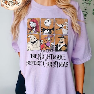 May include: A purple t-shirt with a graphic print of characters from the movie "The Nightmare Before Christmas". The text "est. 1993" and "The Nightmare Before Christmas" are printed on the shirt.