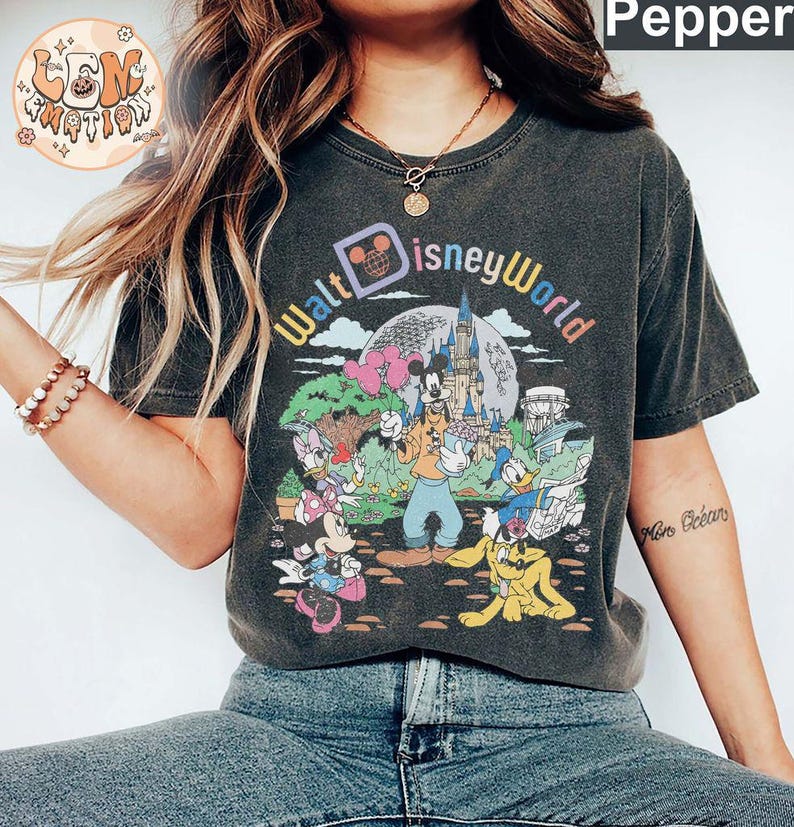 May include: A black t-shirt with a vintage-style graphic of Mickey Mouse and friends at Walt Disney World. The text "Walt Disney World" is printed in a colorful arc above the characters.