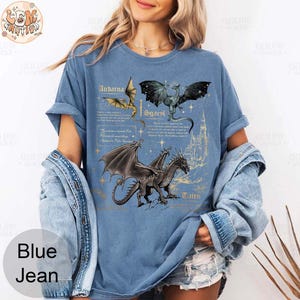 May include: A blue t-shirt with a graphic of three dragons and text that reads "Andarna, Scaevl, Tauro".