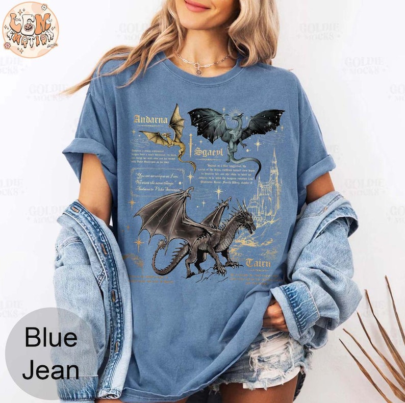 May include: A blue t-shirt with a graphic of three dragons and text that reads "Andarna, Scaevl, Tauro".
