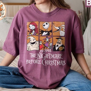 May include: A purple t-shirt with a graphic print of characters from the movie The Nightmare Before Christmas. The graphic includes Jack Skellington, Sally, Oogie Boogie, and Zero. The text "est. 1993 The Nightmare Before Christmas" is printed below the graphic.