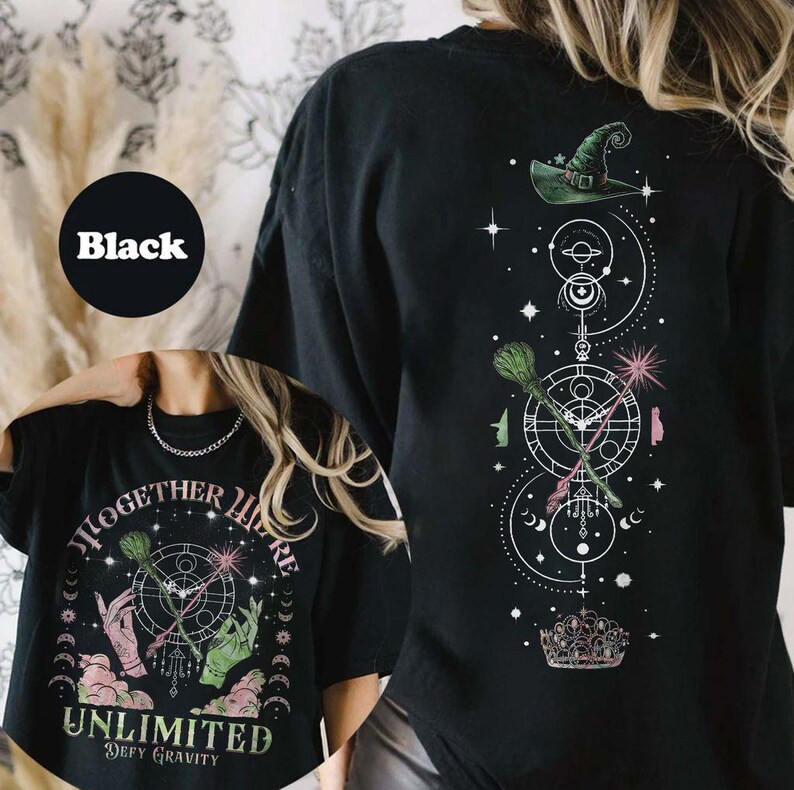 May include: Black t-shirt with a graphic print of a witch's hat, broom, and wand with the text "Together We're Unlimited Defy Gravity".