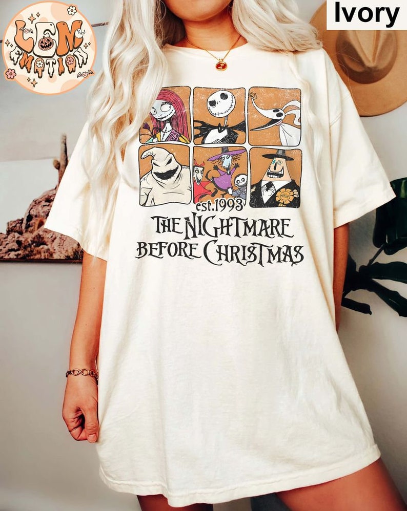 May include: A white t-shirt with a vintage-style graphic of characters from the movie "The Nightmare Before Christmas". The graphic features a grid of six squares, each containing a different character from the film. The text "est. 1993" and "The Nightmare Before Christmas" is printed below the graphic.