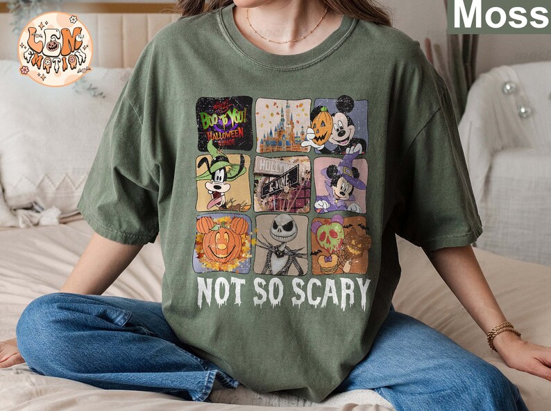 May include: Green t-shirt with a multi-colored graphic print of various Disney characters and the text "Boo to You! Halloween Time" and "Not So Scary".
