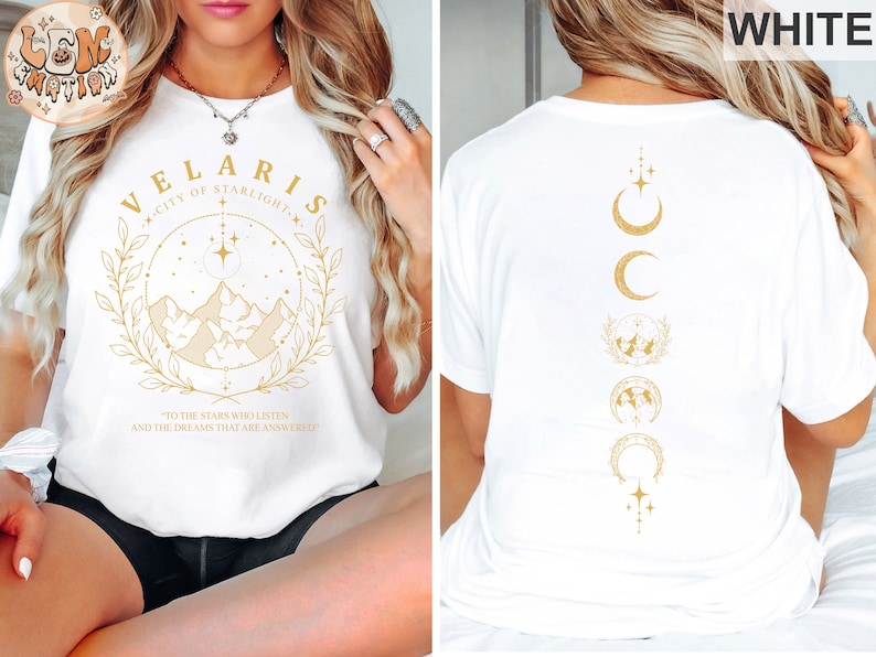May include: White t-shirt with gold text and graphics. The front features "VELARIS CITY OF STARLIGHT" with a mountain and star design. The back displays a vertical design of moons, stars, and a globe. The shirt includes the text "TO THE STARS WHO LISTEN AND THE DREAMS THAT ARE ANSWERED."
