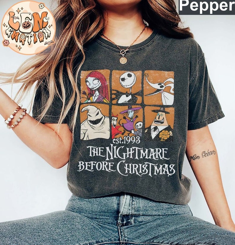 May include: A black t-shirt with a vintage-style graphic of characters from the movie "The Nightmare Before Christmas". The graphic features Jack Skellington, Sally, Oogie Boogie, and Zero. The text "est. 1993" and "The Nightmare Before Christmas" is printed below the graphic.