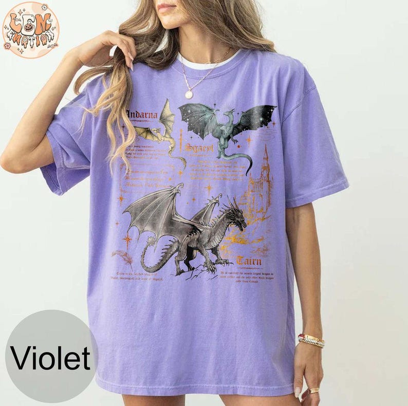 May include: A purple t-shirt with a graphic print of three dragons. The dragons are labeled "Indarva", "Sygra", and "Cairn".