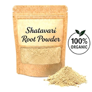 May include: A brown paper bag of Shatavari Root Powder with a clear window, and a pile of powder next to it. The bag has the words "Shatavari Root Powder" printed on it. A circular logo that says "100% ORGANIC" is on the right.