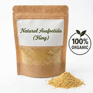 May include: A brown paper bag with a clear window containing a yellow powder, labeled "Natural Asafoetida (Hing)". A small pile of the powder sits in front of the bag. A circular logo reads "100% ORGANIC".