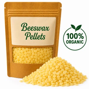 May include: A brown stand-up pouch with a clear window containing small yellow beeswax pellets. The label reads Beeswax Pellets in green text. A circular green logo to the right features two leaves and the text 100% ORGANIC. A pile of yellow beeswax pellets sits in front of the pouch.
