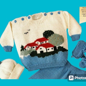 May include: A white knitted baby sweater with a blue trim and a colorful house scene design. The sweater is paired with a matching white knitted hat with a blue pom-pom and blue knitted booties.