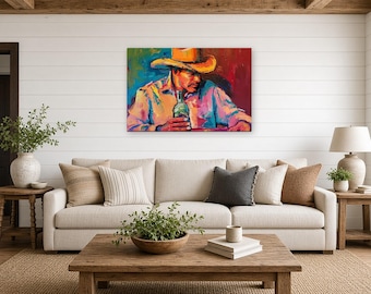 Op de afbeelding: Een rechthoekige canvas print met een impressionistisch schilderij van een persoon met een cowboyhoed en een overhemd, die een glazen fles vasthoudt. Het kunstwerk gebruikt levendige, gedurfde streken in rood, blauw, geel en oranje.
