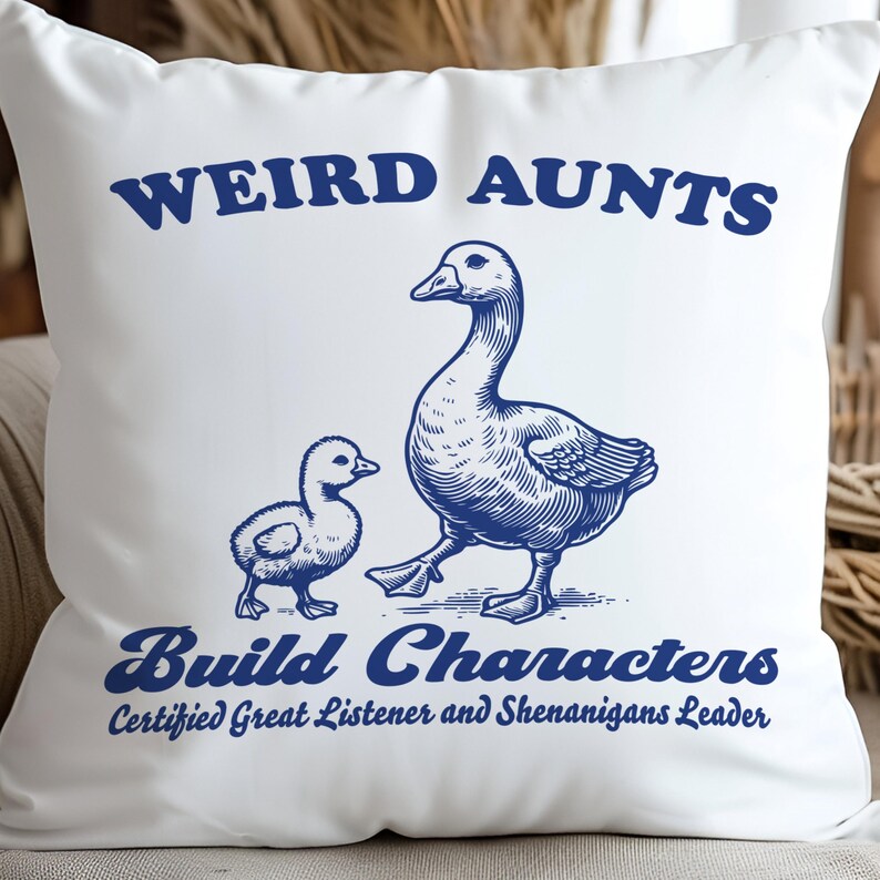 May include: White throw pillow with blue text that reads "Weird Aunts Build Characters Certified Great Listener and Shenanigans Leader".  Two blue geese are illustrated on the pillow, one large and one small.