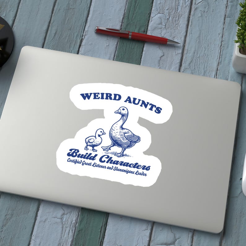 May include: A blue and white sticker with the text "Weird Aunts Build Characters" and the text "Certified Great Listener and Shenanigans Leader". The sticker features a cartoon illustration of two geese walking.