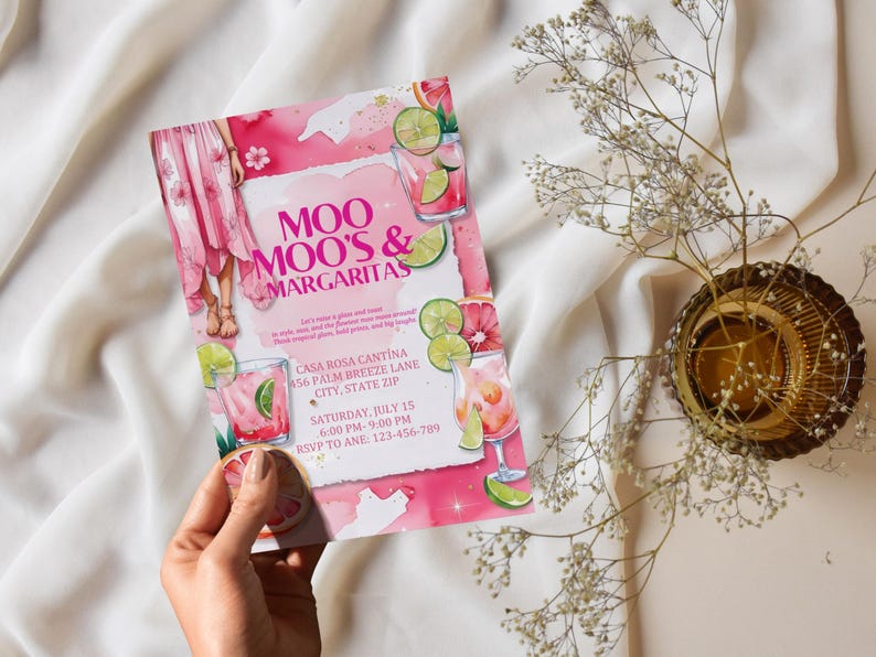 May include: A pink invitation with the text "Moo Moo's & Margaritas" and event details. The design includes watercolor illustrations of cocktails, lime slices, and a woman in a pink dress. The invitation is held by a hand.