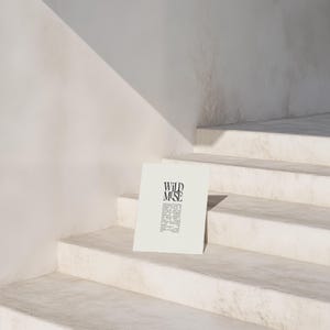 May include: A white poster with black text that reads "WILD MUSE" on a white staircase. The text is a definition of the word "muse".
